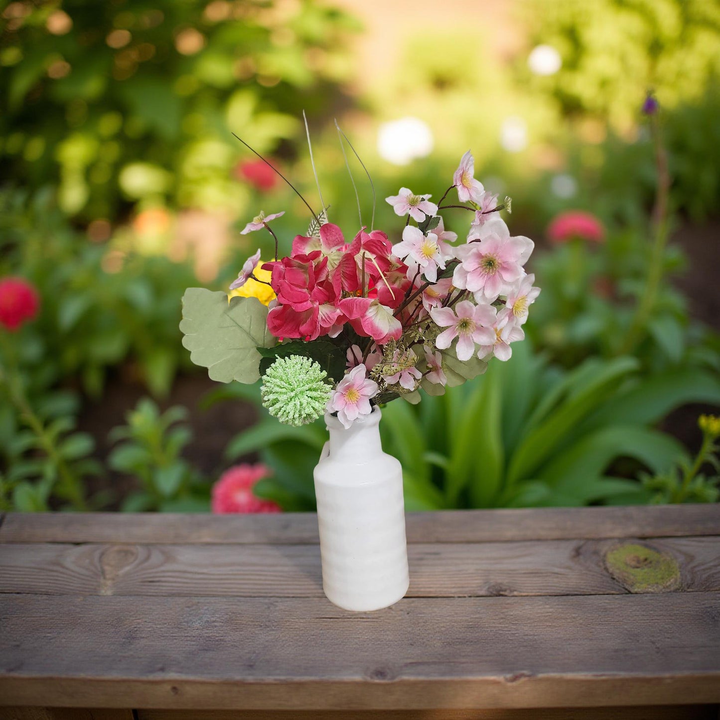 Rustic White Ceramic Vase Adorned with Beautiful Pink Flowers